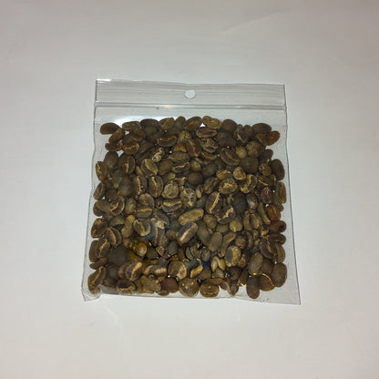 A small clear plastic zip-top bag filled with brown and tan coffee beans, photographed on a plain off-white background.