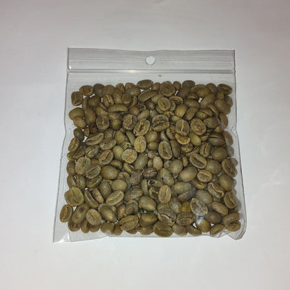 A clear plastic zip-top bag filled with green coffee beans, photographed on a plain white background.